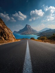 Asphalt road leading to a mountain vista