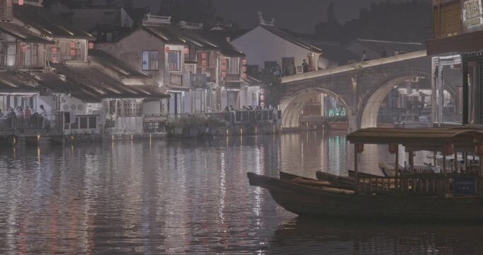 Idyllic night scene with lantern-adorned buildings by the riverbank. Zhujiajiao, Shanghai, China