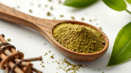 Natural henna powder in a wooden spoon with fresh green leaves, used for organic hair dyeing and traditional body art