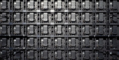 Backside view of an LED video wall with multiple electronic modules, wires, and connectors.