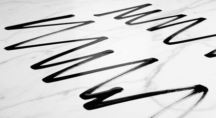 Fototapeta premium Close-up of black zig-zag lines on a white marble surface, creating an abstract pattern.