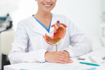 Gastroenterologist consultation, treatment of stomach diseases and ulcers. Doctor holding on...