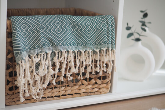 Woven basket with blanket in modern interior