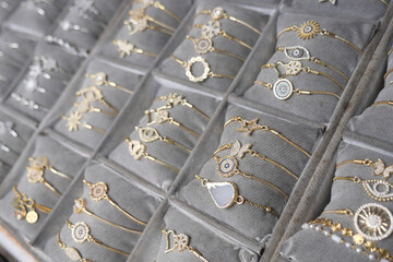 Beautiful collection of delicate gold bracelets on display