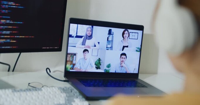 Closeup young Asia female programmer meeting video conference discuss work prompt AI bot IT app program nomad, game, terminal coding, user interface, data center on desktop computer at home office.