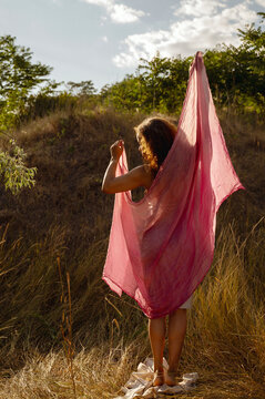 African American woman in the sun outdoors with fabric