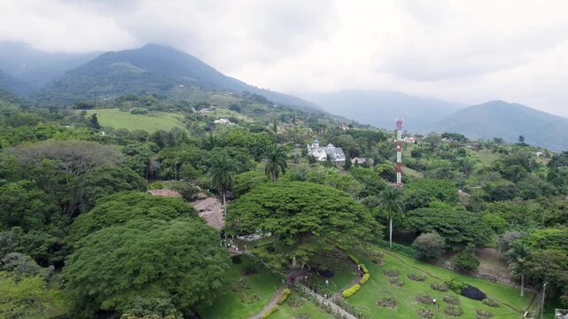 Aerial drone footage of Hacienda El Para&iacute;so located in Santa Elena El Cerrito Valle del Cauca Colombia showing historic colonial house and surrounding green landscape.