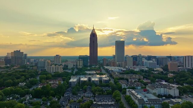 Atlanta highrise buildings with Bank of America Plaza skyscraper in center at sunset, Midtown Atlanta apartments and condominium complex surrounded by greenery, Peachtree Street, Georgia, Aerial