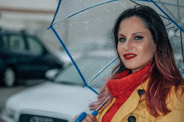 young woman with umbrella in the rain on the street