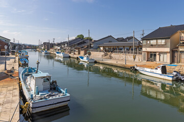 川沿いに建ち並ぶ民家と係留された漁船