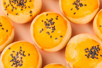Golden Egg Tart Pastries with Black Sesame Seeds Traditional Asian Bakery Desserts on Pink Background