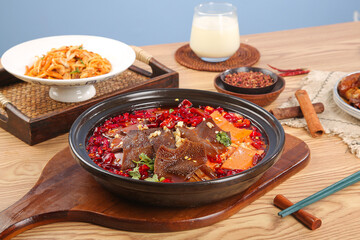 Traditional Chinese Hot Pot with Spicy Red Broth and Fresh Ingredients on Wooden Table
