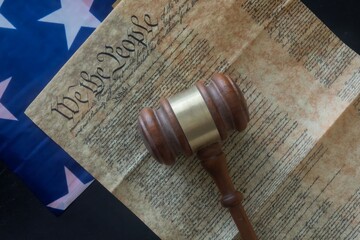 Gavel on U.S. Constitution with Flag