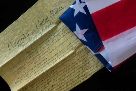 U.S. Constitution and American Flag Close-Up - Powered by Adobe