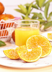 Fresh Orange Juice with Sliced Oranges and Tropical Fruits on Wooden Board