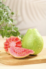 Fresh Red Heart Guava Fruit from Guangxi China Sliced on Wooden Board with Soft Cream Flesh