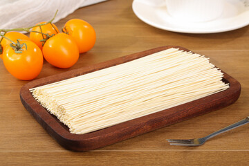 Raw Hanging Noodles on Wooden Board with Fresh Tomatoes Kitchen Cooking Preparation