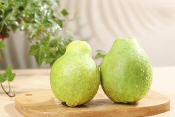 Fresh Ripe Guavas with Water Droplets on Wooden Board - Tropical Fruit Still Life