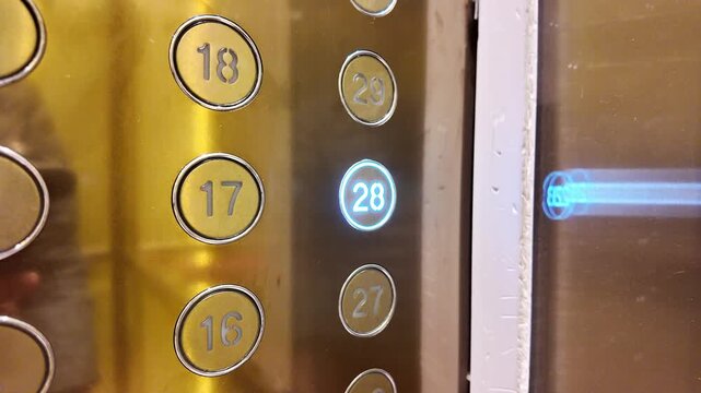 hand pressing button in an elevator