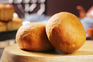 Traditional Handmade Mooncakes with Egg Yolk and Ham Filling on Wooden Board