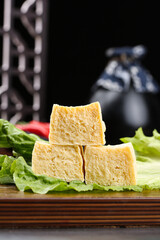 Fresh Golden Tofu Cubes on Lettuce Leaves - Healthy Vegetarian Protein Food Ingredient