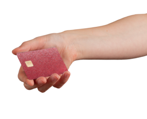Hand holding a red glitter textured bank card with chip, gesture of offering or making a payment,