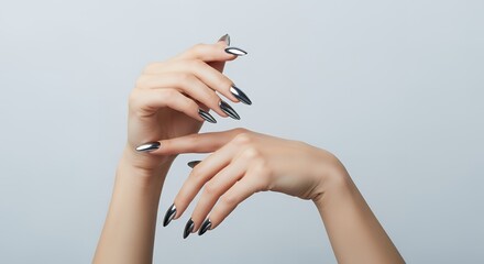 Elegant woman's hands with long pointed shiny chrome finished fingernails in various graceful poses against a clean light gray backdrop Manicure Metallic Fashion Beauty Glamour Elegance