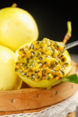 Fresh Golden Passion Fruit from Hainan China with Juicy Pulp and Seeds on Wooden Board