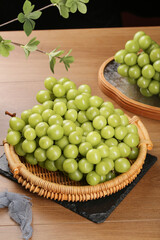 Fresh Green Grapes in Wicker Baskets on Wooden Table - Healthy Organic Fruit Display
