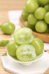 Fresh Green Grapes Cut in Half Showing Sweet Juicy Interior on Wooden Table