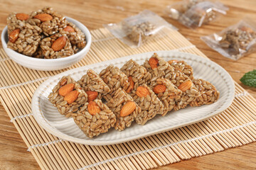 Handmade Granola Bars with Sunflower Seeds and Nuts on Bamboo Mat - Healthy Snack Food