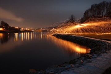 Nighttime fire spin over tranquil lake