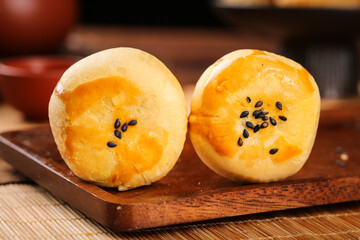 Asian Egg Yolk Pastries with Black Sesame Seeds on Wooden Board Traditional Bakery Desserts