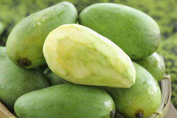 Fresh Hainan Green Mangoes with Ivory Flesh in Wicker Basket - Raw Tropical Fruit