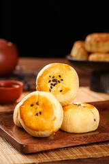 Chinese Egg Custard Tarts with Black Sesame Seeds on Wooden Board - Traditional Asian Dessert Pastries