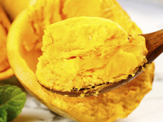 Golden Mango Ice Cream in Natural Fruit Shell with Wooden Spoon - Tropical Frozen Dessert