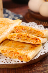 Handmade Spicy Potato Pancakes with Shredded Vegetable Filling on Wooden Table