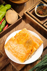 Handmade shredded potato pancakes breakfast with spicy peppers and fresh ingredients on wooden table