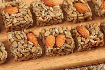 Handmade Nut and Seed Energy Bars with Almonds and Sunflower Seeds on Wooden Board