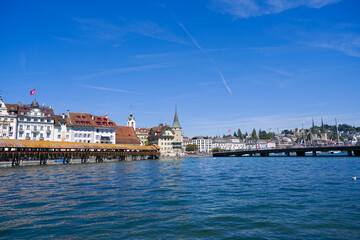 Obraz premium Scenic view of famous Chapel Bridge with Reuss River and bridge named Seebrücke at the old town of Swiss city of Luzern on a sunny summer day. Photo taken August 25th, 2025, Lucerne, Switzerland.