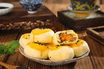 Chinese Egg Custard Pastries with Golden Filling Traditional Asian Dessert on Wooden Table