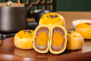 Chinese Egg Yolk Pastries with Bean Paste Filling and Sesame Seeds on Wooden Board