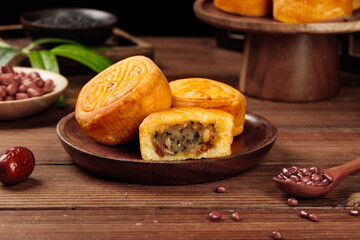 Traditional Chinese Mooncakes with Mixed Filling for Mid-Autumn Festival Celebration on Rustic Wood Background
