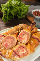 Handmade Air-Dried Duck Slices on Plate with Fresh Lettuce - Traditional Farmers Market Delicacy