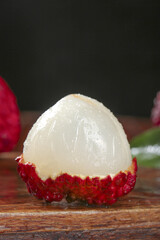 Fresh Peeled Hainan Lychee Fruit with Translucent White Flesh on Wooden Table