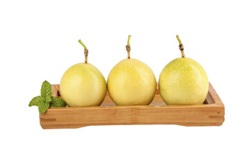 Fresh Golden Passion Fruits in Wooden Tray with Mint on White Background