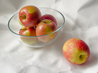 Apples in a glass bowl on a white background