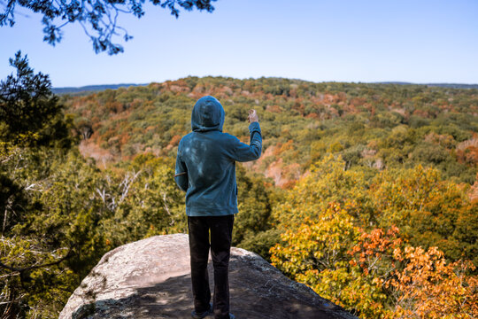 Kid standing on rocky overlook at Garden of the Gods in Illinois