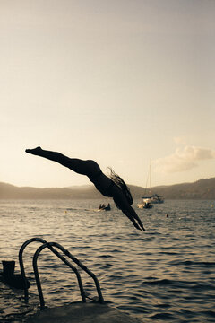 a woman jumping in to the water in Mallorca