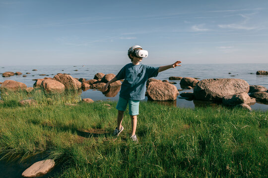 Child in virtual glasses in fabulously beautiful place